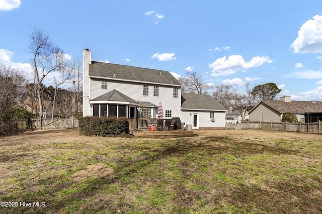 rear view of property featuring a sunroom and a yard