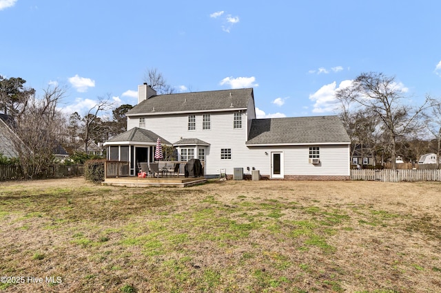 back of house with cooling unit and a yard