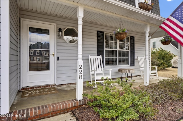 view of exterior entry featuring a porch