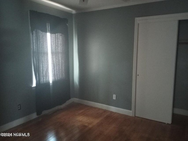 unfurnished bedroom with hardwood / wood-style flooring and a closet