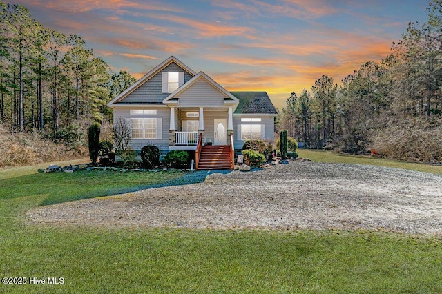 view of front of house featuring a porch and a lawn