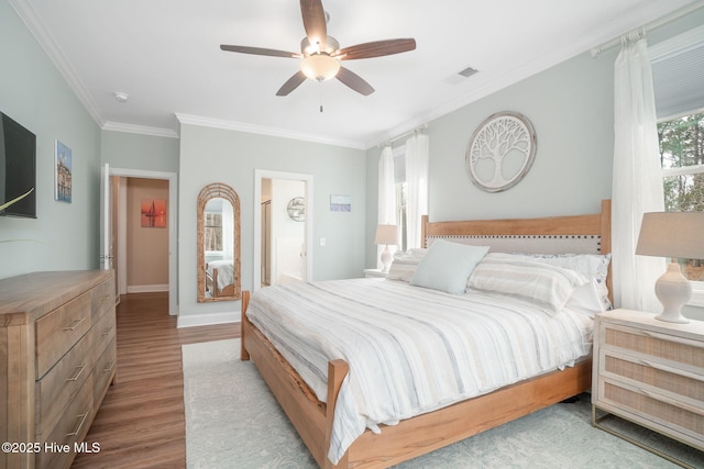 bedroom featuring crown molding, ceiling fan, and light wood-type flooring