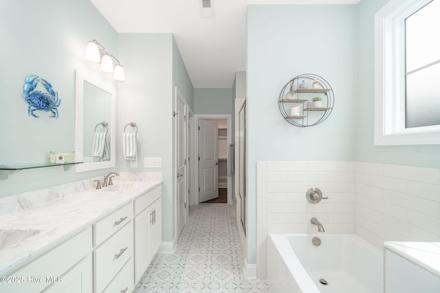 bathroom with vanity and a bathtub