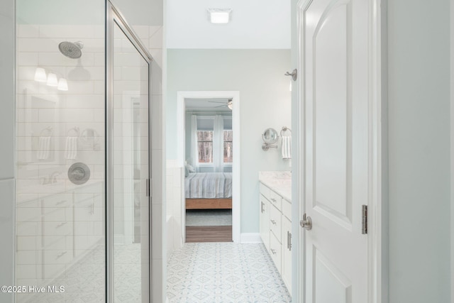 bathroom with a shower with door and vanity