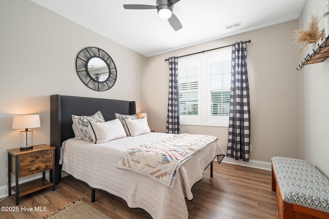 bedroom with dark wood-type flooring and ceiling fan