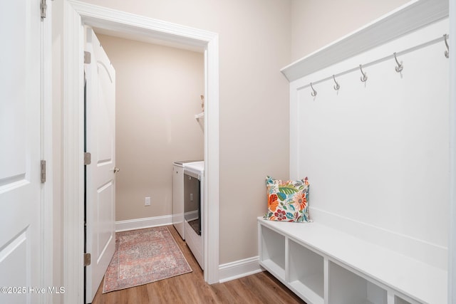 mudroom with hardwood / wood-style flooring and independent washer and dryer