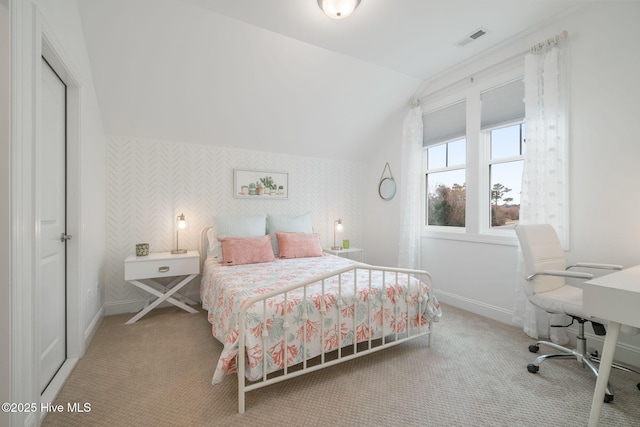 carpeted bedroom with lofted ceiling