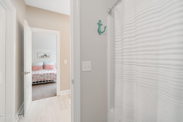 corridor with hardwood / wood-style flooring