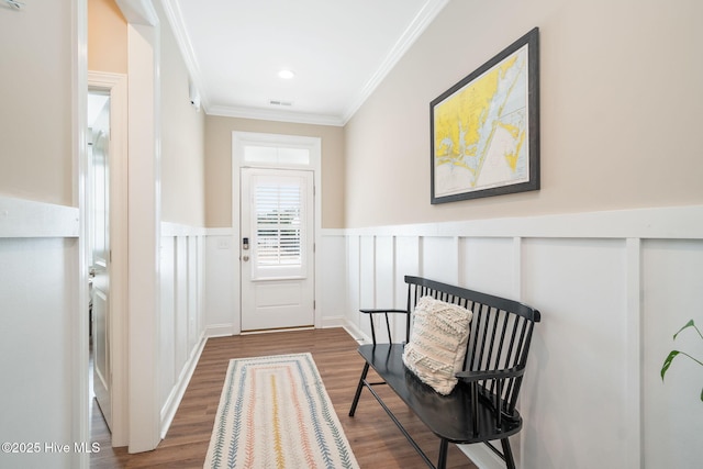 entryway with ornamental molding and dark hardwood / wood-style flooring