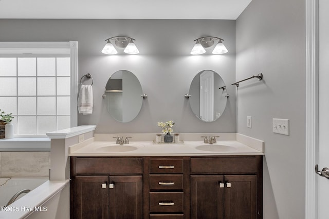 full bath with double vanity and a bath