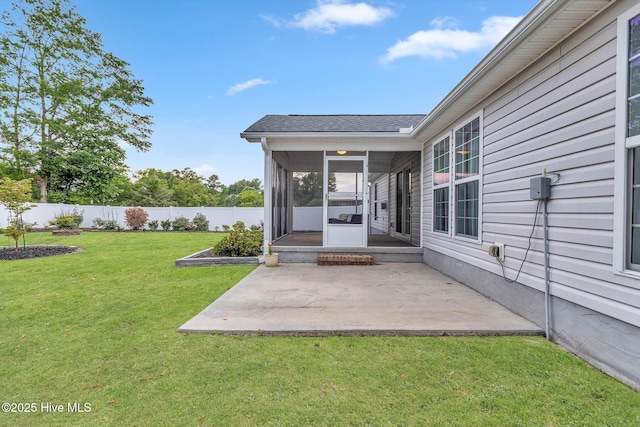 view of yard featuring a sunroom and a patio area