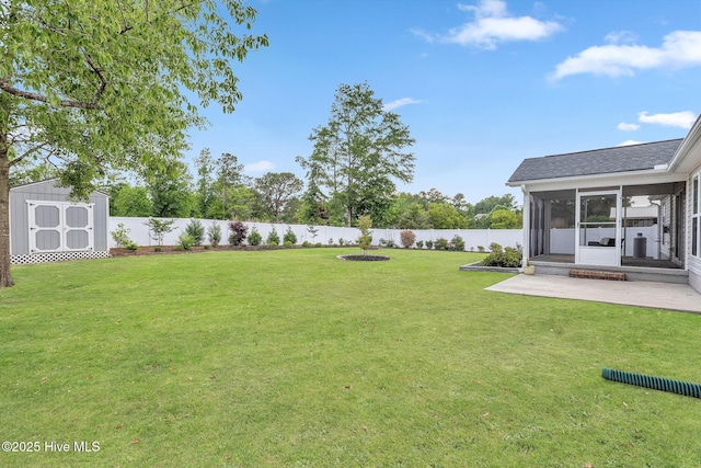 view of yard with a sunroom, a shed, an outdoor structure, and a patio