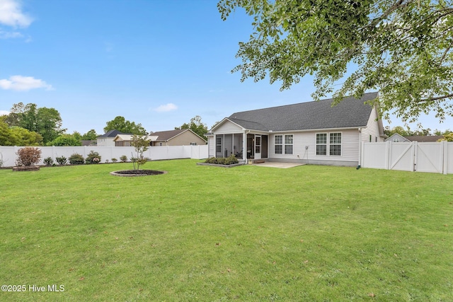 rear view of house featuring a gate, a sunroom, a patio, and a shingled roof