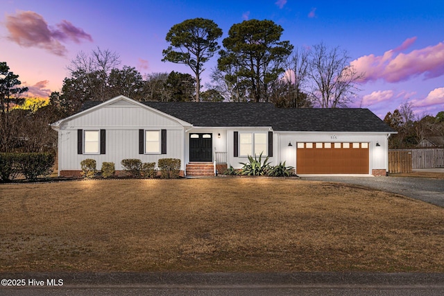 view of front of property featuring a yard and a garage