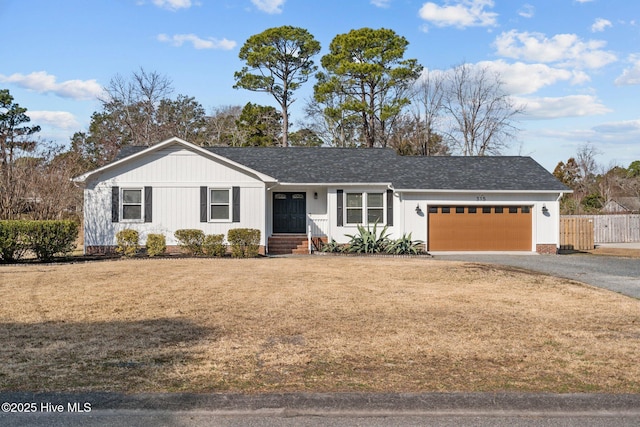 ranch-style home with a garage and a front yard