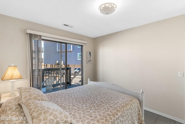 bedroom featuring tile patterned flooring and access to outside