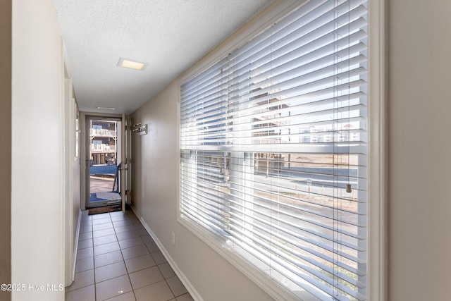 1928 New River Inlet Rd Unit 215, North Topsail Beach, NC 28460 - bedroom with a textured ceiling, baseboards, and tile patterned flooring