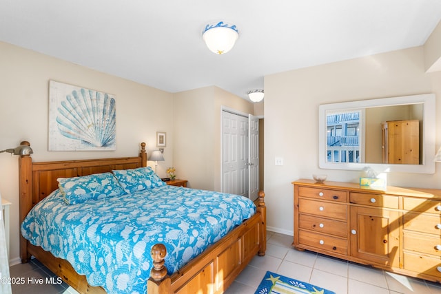 tiled bedroom featuring a closet