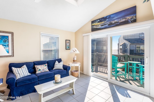 1928 New River Inlet Rd Unit 215, North Topsail Beach, NC 28460 - living area with baseboards, ceiling fan with notable chandelier, light tile patterned flooring, and lofted ceiling
