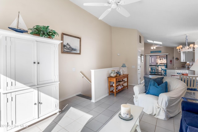 living room with ceiling fan with notable chandelier, light tile patterned floors, and lofted ceiling