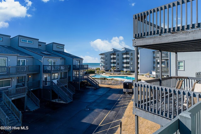 view of patio / terrace featuring a grill and a pool side deck with water view