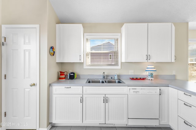 kitchen with white cabinetry, dishwasher, and sink