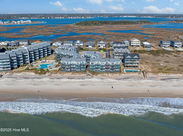 drone / aerial view with a water view and a beach view