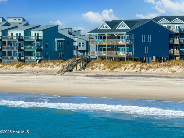 exterior space featuring a beach view and a water view