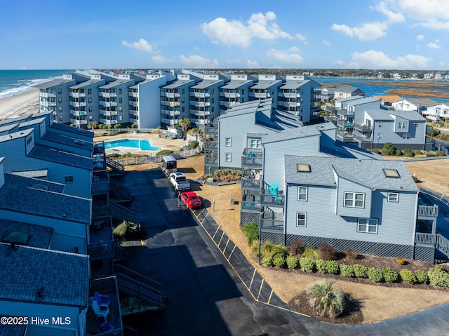 drone / aerial view with a beach view and a water view