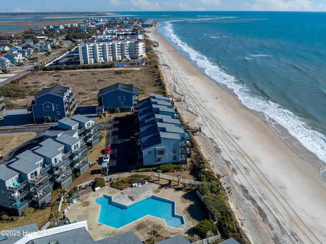 drone / aerial view with a water view and a beach view