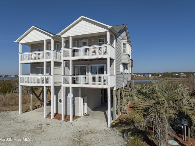 coastal inspired home with a carport and a balcony