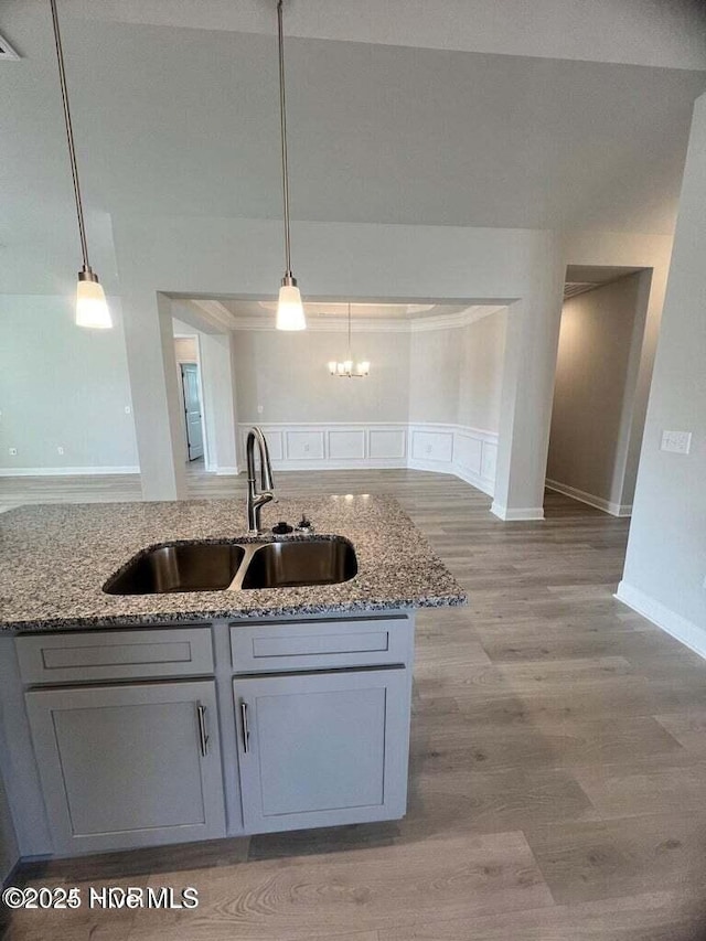 1132 Coral Reef Dr, New Bern, NC 28560 - kitchen featuring a sink, light stone countertops, light wood finished floors, and gray cabinets