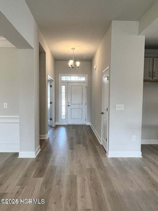 1132 Coral Reef Dr, New Bern, NC 28560 - entrance foyer featuring wood finished floors, baseboards, and a chandelier