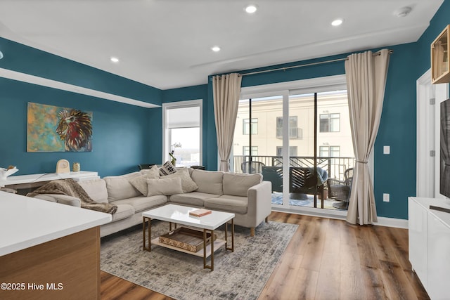 living room featuring dark wood-style floors, baseboards, and recessed lighting