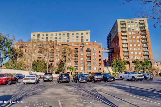 view of building exterior featuring uncovered parking