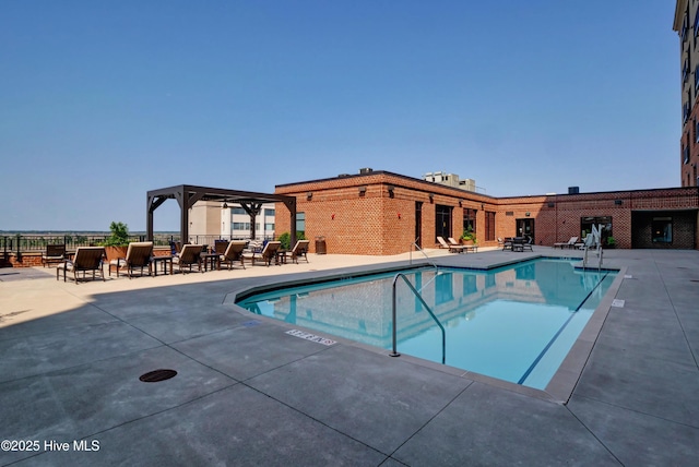 community pool featuring a pergola, a patio, and fence