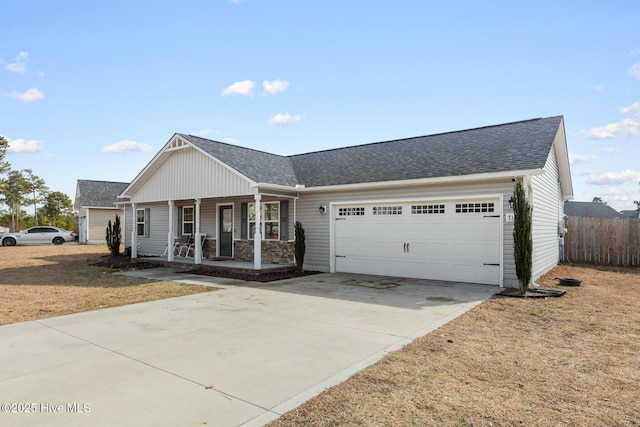 ranch-style house featuring a porch, a garage, and a front lawn