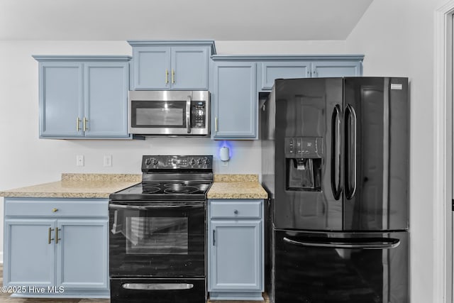 kitchen featuring blue cabinets and black appliances