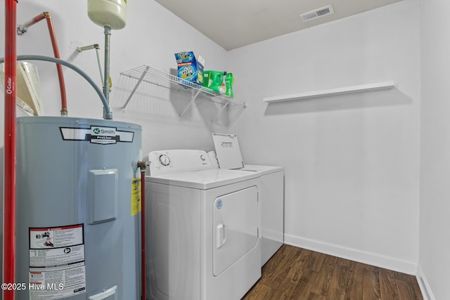 laundry area featuring dark hardwood / wood-style flooring, electric water heater, and independent washer and dryer