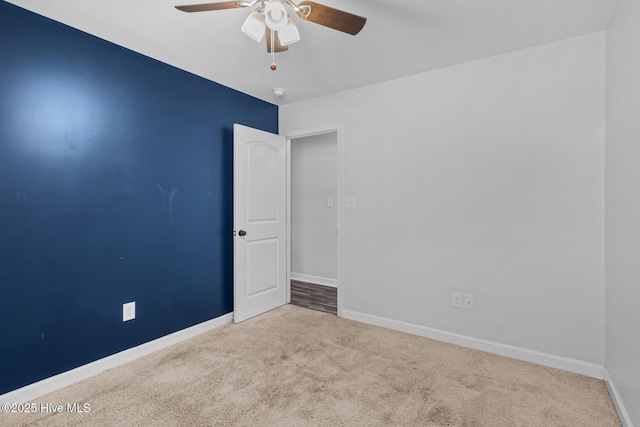 empty room featuring light carpet and ceiling fan