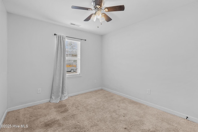 spare room featuring light carpet and ceiling fan