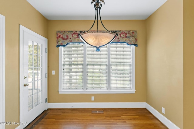 1824 Starfix Ter, Wilmington, NC 28405 - unfurnished dining area featuring wood finished floors