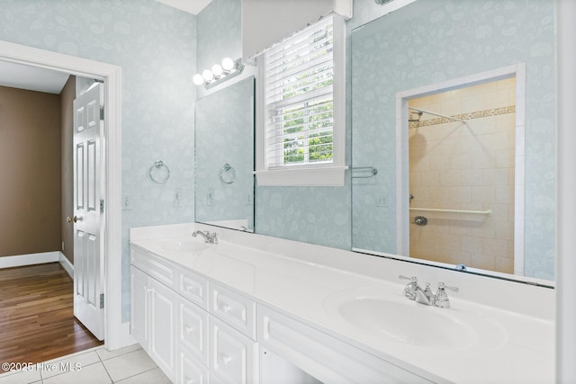 1824 Starfix Ter, Wilmington, NC 28405 - full bath with double vanity, wallpapered walls, and tile patterned flooring