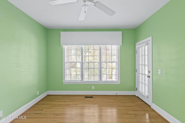 1824 Starfix Ter, Wilmington, NC 28405 - unfurnished room with healthy amount of natural light, light wood finished floors, and ceiling fan