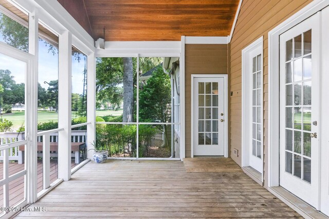 1824 Starfix Ter, Wilmington, NC 28405 - unfurnished sunroom with wooden walls and wood-type flooring