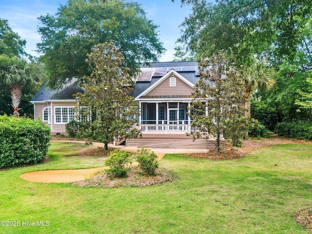 1824 Starfix Ter, Wilmington, NC 28405 - rear view of property with a sunroom, a lawn, and solar panels
