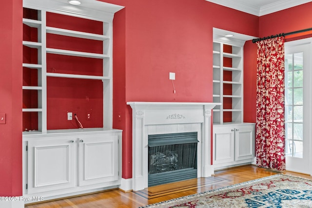 1824 Starfix Ter, Wilmington, NC 28405 - unfurnished living room featuring crown molding, a tiled fireplace, and light wood finished floors