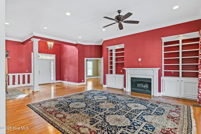 1824 Starfix Ter, Wilmington, NC 28405 - living room featuring a ceiling fan, built in shelves, ornamental molding, wood finished floors, and recessed lighting