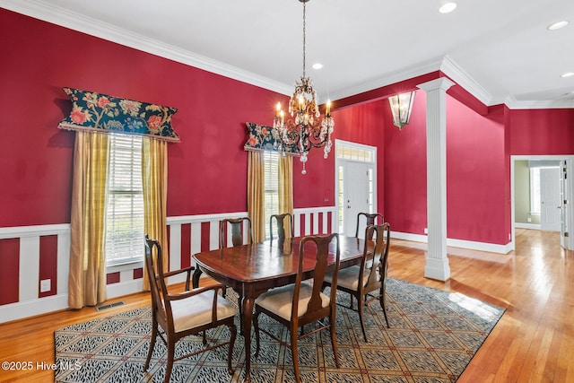 1824 Starfix Ter, Wilmington, NC 28405 - dining area featuring ornamental molding, a chandelier, wood finished floors, decorative columns, and recessed lighting