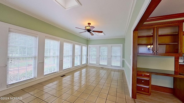 unfurnished sunroom with ceiling fan